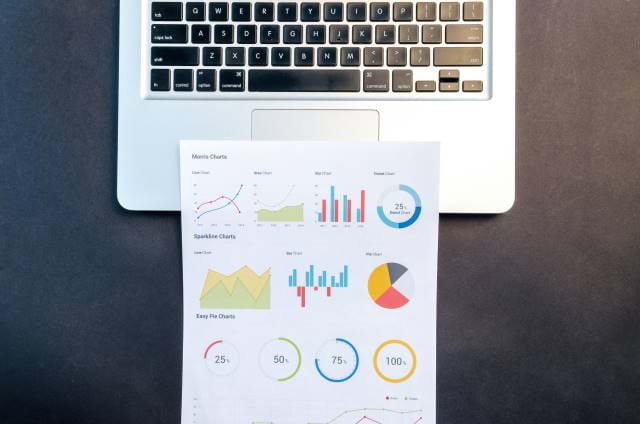 Screenshot of a chart on a paper with a laptop