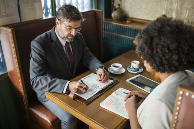 Man interviewing someone in a restaurant