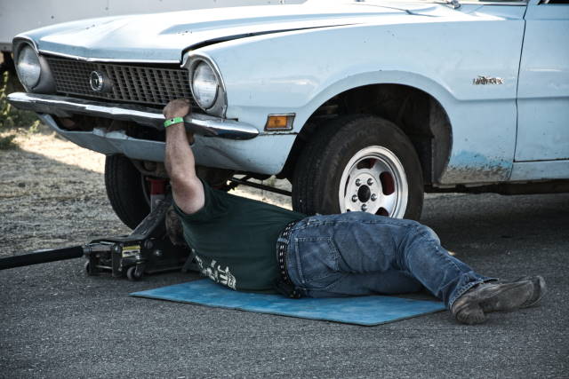Man under a car fixing it