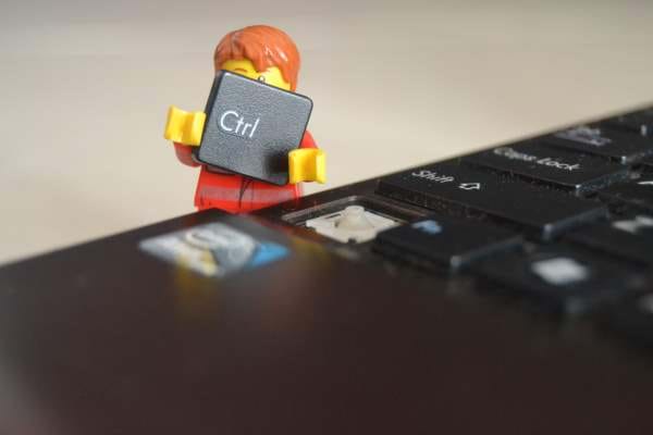Lego character holding a ctrl key from keyboard