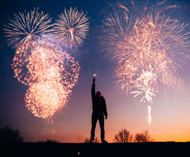 Man holding up a glass for the New Year