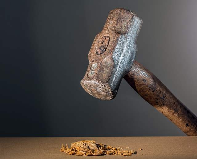 Hammer smashing a walnut