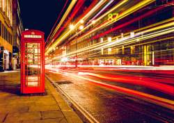 Speedy Bus Flying By a London Telephone Booth