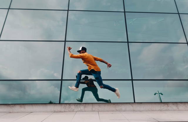 Man running on stairs in front of a building