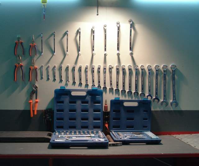 Collection of tools on a peg board.