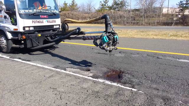 Truck filling in a pothole (taken from YouTube)