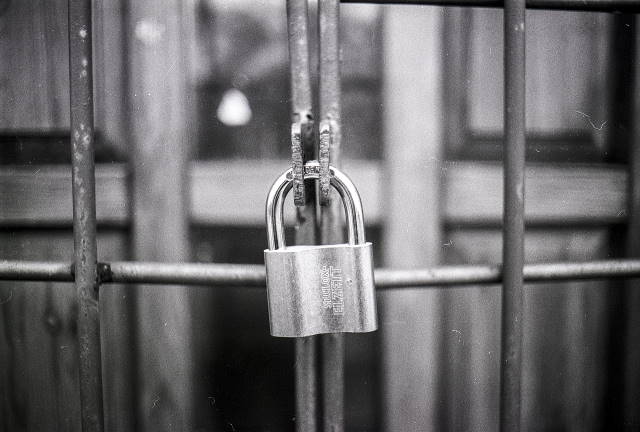 Black and White picture of padlock on a fence