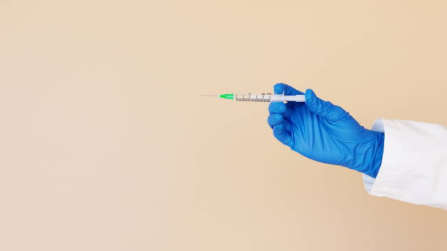 A hand holding an injection needle