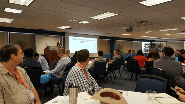 Dog Food Con 2018 Keynote Rows of desks pointing to a large screen