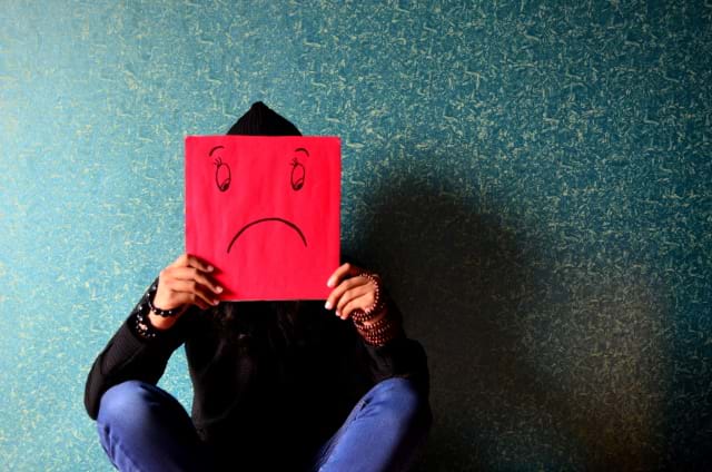 Yeah, this was one of THOSE weekends! Person holding a picture of a frowny face