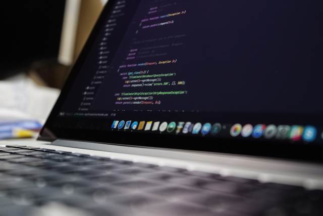 Code on a laptop -- Classic! Open Laptop with Code on the screen