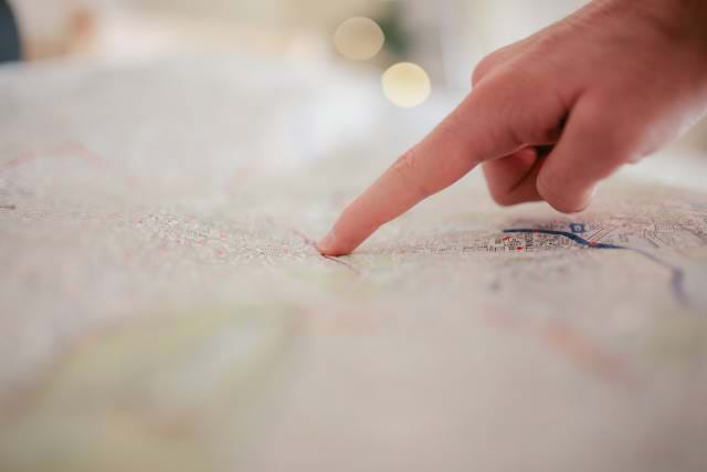 Hand pointing on a map