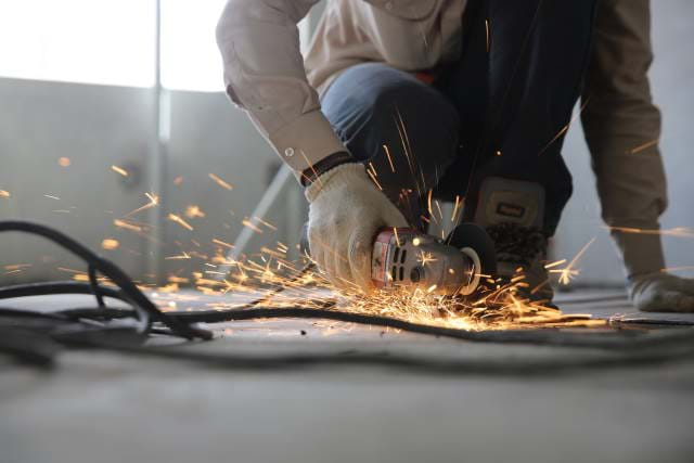 Construction worker using a grinder