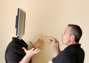 Man screaming at computer