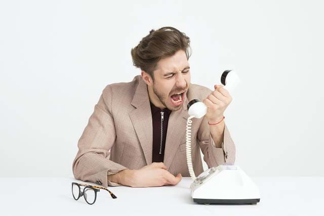 Man Screaming Into A Phone