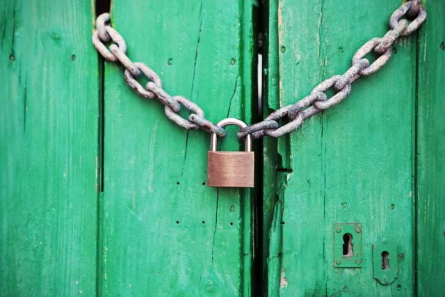 Lock with a chain protecting a door