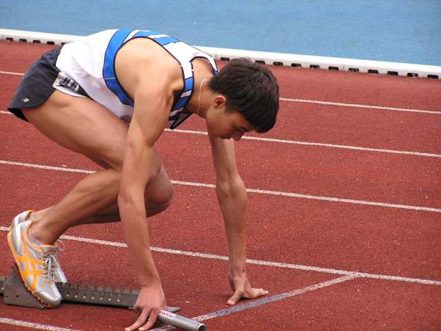 A runner getting ready to race.