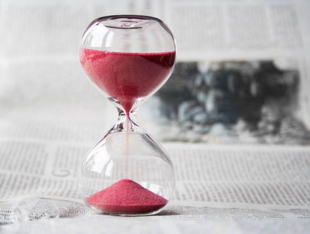 Hourglass containing red sand